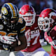 Missouri wide receiver Tauski Dove tries to shake free from Hayden Henry and Montaric Brown against Arkansas in a 2021 loss.
